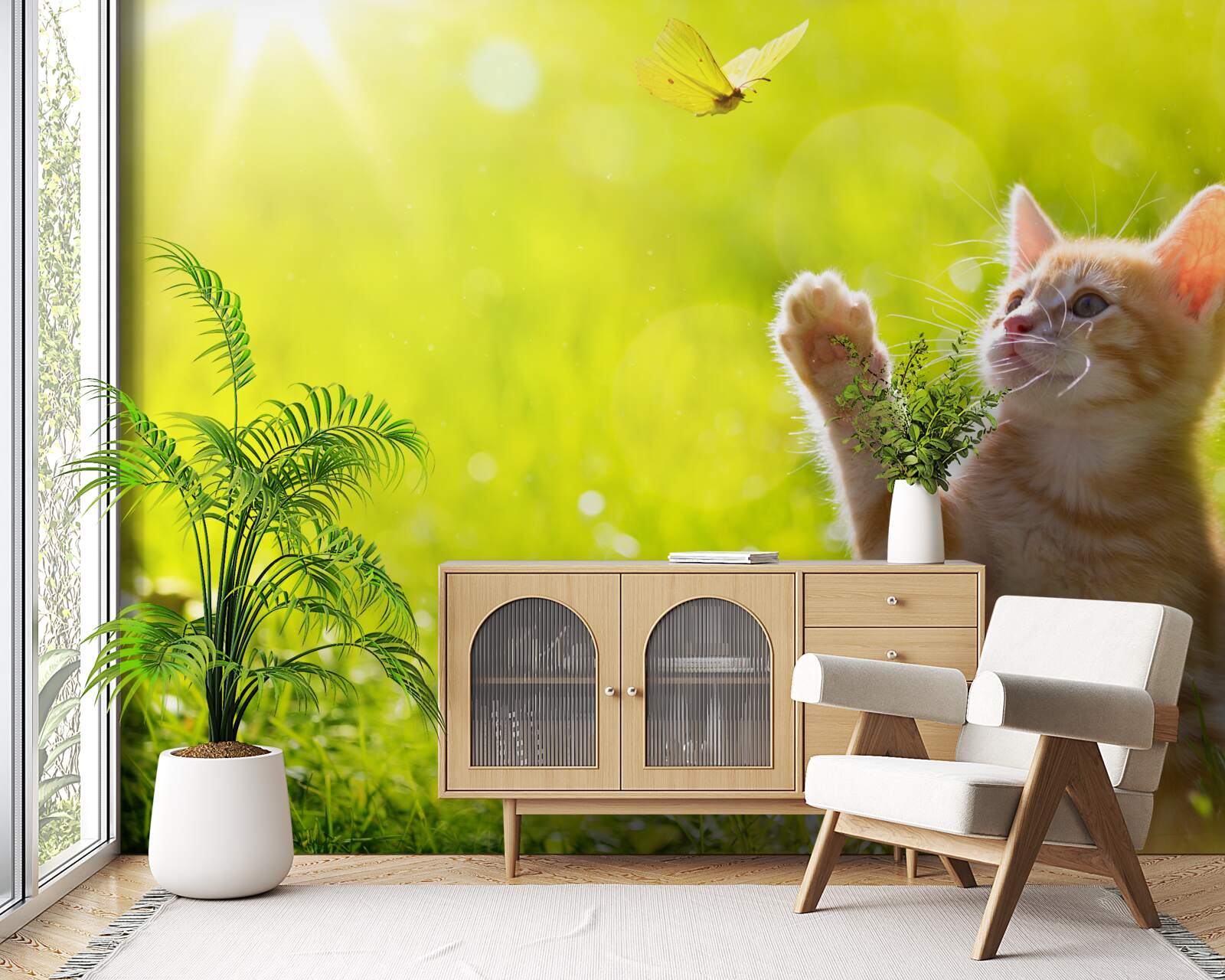 Фотошпалери маленький кіт грається з метеликом у зеленому полі